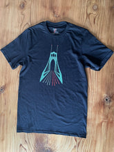 A black cotton short sleeve t-shirt with an elevation of the St. John's bridge, blurred traffic lights and red lights on top of the bridge